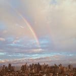 Two rainbows over a city.